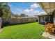 Backyard with grassy area and wood fence at 1957 Temple Ter, Clearwater, FL 33764