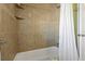 Clean bathroom with a bathtub and neutral-toned tile at 1957 Temple Ter, Clearwater, FL 33764