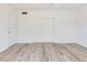 Simple bedroom with wood-look floors and neutral walls at 2027 Inner S Cir, St Petersburg, FL 33712