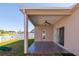 Covered patio with tile flooring, sliding glass doors, and ceiling fan at 24839 Panacea Ct, Lutz, FL 33559