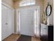 Bright entryway with white door, tile floors, and storage cabinet at 24839 Panacea Ct, Lutz, FL 33559