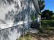 Gray house exterior featuring a side entrance, AC unit, and landscaping at 2536 61St S Ave, St Petersburg, FL 33712