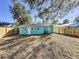 Spacious backyard with a wooden fence and large tree at 2557 17Th S Ave, St Petersburg, FL 33712