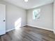 Sunny bedroom with hardwood floors and a door to hallway at 2557 17Th S Ave, St Petersburg, FL 33712