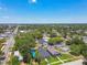Wide aerial shot captures a lively suburban neighborhood with streets, sidewalks, green trees and blue skies at 2735 36Th N Ave, St Petersburg, FL 33713