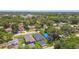 Suburban neighborhood aerial view showcases homes surrounded by mature trees, blue skies and clear blue water at 2735 36Th N Ave, St Petersburg, FL 33713