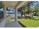 View of the backyard featuring lush green grass, storage sheds and a covered area from the porch at 2735 36Th N Ave, St Petersburg, FL 33713