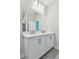 Bathroom featuring double vanity with stone countertop, and tiled walk-in shower at 2735 36Th N Ave, St Petersburg, FL 33713