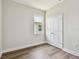 Bedroom with wood-look floors, white walls, white trim, a window, and a double door closet at 2735 36Th N Ave, St Petersburg, FL 33713