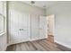 This bedroom features wood-look floors, white walls, white trim, and a large double door closet at 2735 36Th N Ave, St Petersburg, FL 33713