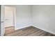 A bedroom featuring wood-look floors, white walls and trim, and a white door at 2735 36Th N Ave, St Petersburg, FL 33713