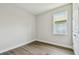 This bedroom has wood-look floors, a window, white walls, and white trim at 2735 36Th N Ave, St Petersburg, FL 33713