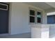 Close-up of the covered entry featuring new windows and neutral tones at 2735 36Th N Ave, St Petersburg, FL 33713