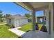 Rear exterior view of the house and a small building, showing the yard and sidewalk at 2735 36Th N Ave, St Petersburg, FL 33713