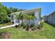 Lush landscaping and palm trees accentuate the exterior of this charming home at 2735 36Th N Ave, St Petersburg, FL 33713