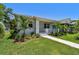 View of the exterior of the home, showing its manicured lawn, landscaping and covered porch at 2735 36Th N Ave, St Petersburg, FL 33713