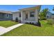 Exterior front view of the home featuring a modern color scheme, and lush green grass at 2735 36Th N Ave, St Petersburg, FL 33713