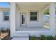 Exterior front porch view with neutral colors, and landscaped surroundings at 2735 36Th N Ave, St Petersburg, FL 33713