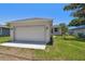 Attached one-car garage with a white door and exterior lighting at 2735 36Th N Ave, St Petersburg, FL 33713