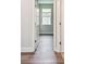 Hallway with wood floors leading to a light-filled room with a window at 2735 36Th N Ave, St Petersburg, FL 33713