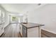 Open-concept kitchen with island, stainless appliances, modern finishes, and wood flooring at 2735 36Th N Ave, St Petersburg, FL 33713