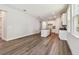 Open-concept living space with wood floors flowing into a kitchen with white cabinets and island at 2735 36Th N Ave, St Petersburg, FL 33713