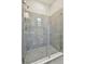 Bathroom featuring tiled walk-in shower and frameless glass door at 2735 36Th N Ave, St Petersburg, FL 33713
