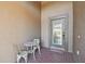 Small front porch with wrought iron table and chairs at 31330 Spoonflower Way, Brooksville, FL 34602