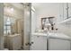 Bathroom with shower, sink, and laundry area at 3214 W Villa Rosa St, Tampa, FL 33611