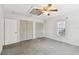 Main bedroom with grey carpet, ceiling fan, and double closets at 3214 W Villa Rosa St, Tampa, FL 33611