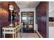 Entryway with mirrored console table and dramatic wallpaper at 4 Belleview Blvd # 402, Belleair, FL 33756