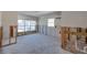 Dining Room under renovation with new flooring and exposed framing at 4211 Shore Acres Ne Blvd, St Petersburg, FL 33703