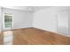 Empty bedroom showcases hardwood floors, light walls, a ceiling fan, and bright windows at 4404 W Azeele St, Tampa, FL 33609