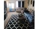 Living room with sofa, coffee table, and patterned rug at 4880 Locust Ne St # 234, St Petersburg, FL 33703