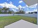 Fenced backyard with large grassy area and patio at 5018 Bella Armonia Cir, Wimauma, FL 33598