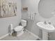 Clean and modern half bathroom with pedestal sink and toilet at 5018 Bella Armonia Cir, Wimauma, FL 33598