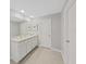 Double vanity bathroom with light-colored cabinets and tile floor at 5018 Bella Armonia Cir, Wimauma, FL 33598