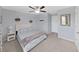 Bedroom with queen-size bed, ceiling fan, and light gray carpet at 5018 Bella Armonia Cir, Wimauma, FL 33598