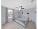 Bedroom with queen-size bed, ceiling fan, and window coverings at 5018 Bella Armonia Cir, Wimauma, FL 33598