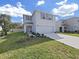 Two-story house with light blue exterior, two-car garage, and small front yard at 5018 Bella Armonia Cir, Wimauma, FL 33598