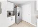 Kitchen features stainless steel refrigerator and granite countertops at 5018 Bella Armonia Cir, Wimauma, FL 33598