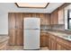 White refrigerator in kitchen with wood cabinets at 5435 20Th N Ave, St Petersburg, FL 33710