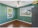 Bedroom with green walls, hardwood floors, and ceiling fan at 5612 18Th St, Zephyrhills, FL 33542