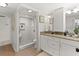 Bathroom boasts granite countertop, white cabinets, and walk-in shower at 5950 Pelican Bay S Plz # 302, Gulfport, FL 33707