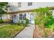 Close-up view of the townhome's front entrance with decorative plants and a security gate at 8706 Cobbler Pl, Tampa, FL 33615