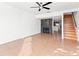 Open living room with tile flooring, a fireplace, and a ceiling fan at 8706 Cobbler Pl, Tampa, FL 33615