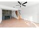 Living room with tile flooring, fireplace, ceiling fan, and staircase at 8706 Cobbler Pl, Tampa, FL 33615