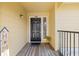 Condo entry with wood flooring, black door, and sunflowers at 8722 Mallard Reserve Dr # 204, Tampa, FL 33614