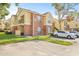 Two-story condo building with brick and siding, parking, and green space at 8722 Mallard Reserve Dr # 204, Tampa, FL 33614