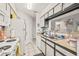 Galley-style kitchen boasting white appliances and granite countertops at 8722 Mallard Reserve Dr # 204, Tampa, FL 33614